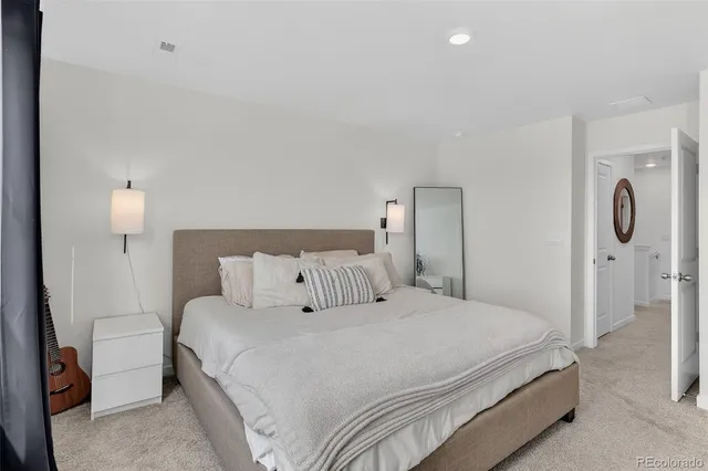 a bedroom with a bed and a lamp