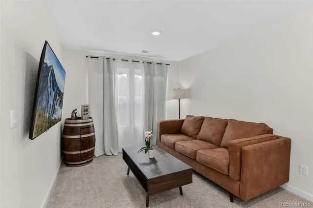 a living room with furniture a couch and a flat screen tv