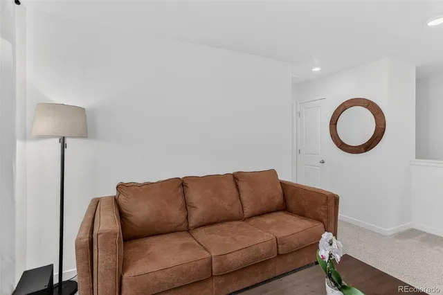 a living room with a couch and a lamp