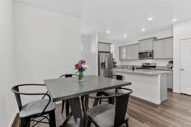 a kitchen with granite countertop white cabinets and appliances