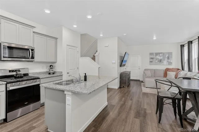 a kitchen with a sink stainless steel appliances and cabinets