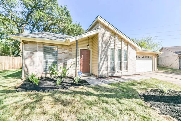 a view of house with backyard and outdoor seating