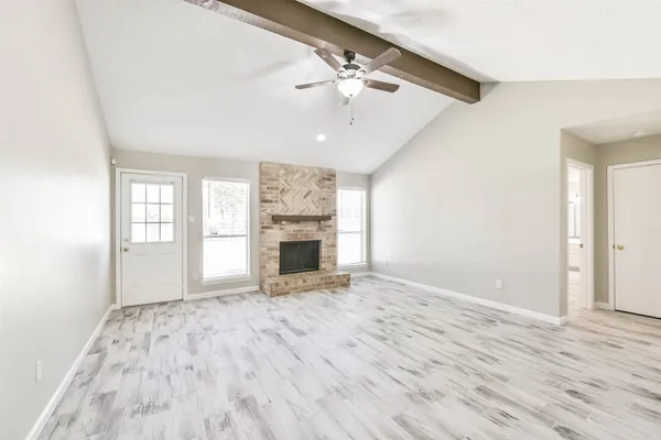 wooden floor in an empty room with a fireplace