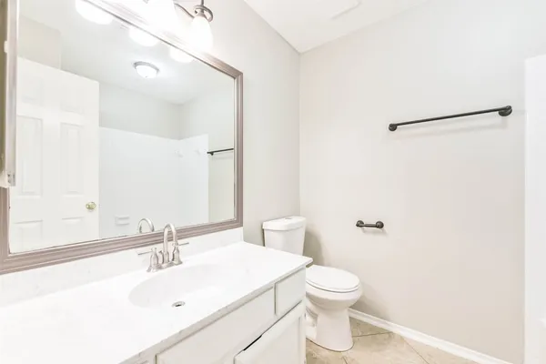 a bathroom with a sink a toilet and a mirror