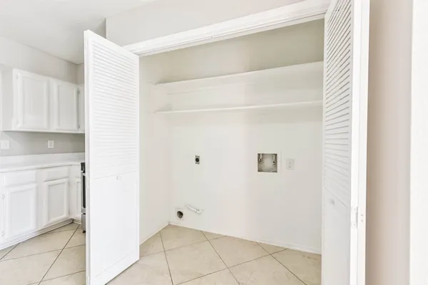 a view of kitchen with white cabinets