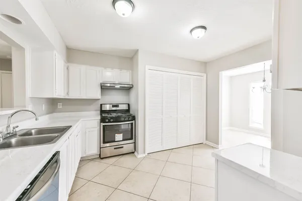a kitchen with a sink cabinets and appliances