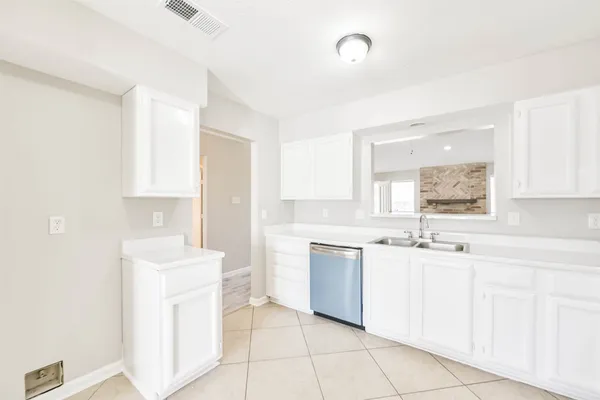 a kitchen with sink cabinets and window