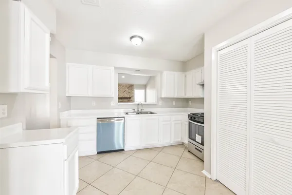 a kitchen with a stove top oven sink and cabinets