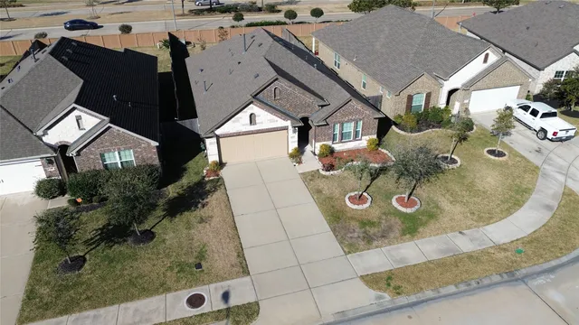 an aerial view of a house with swimming pool and patio