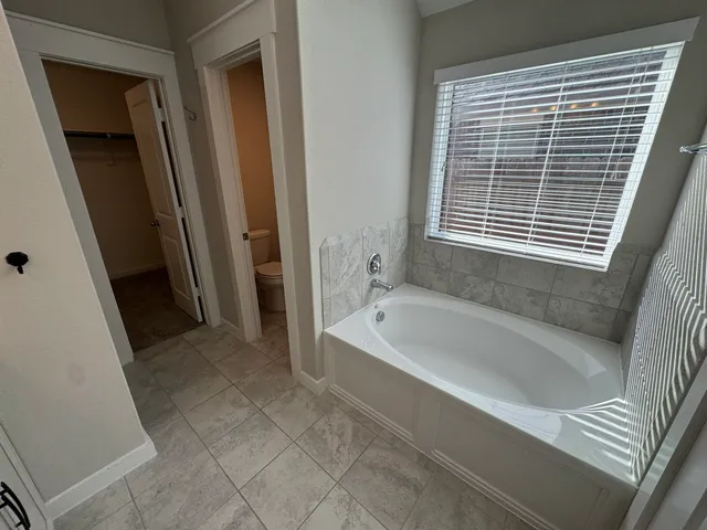 a spacious bathroom with a bathtub and a shower