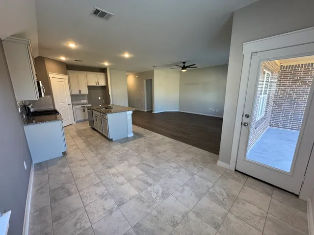 a view of a living room with furniture and a flat screen tv