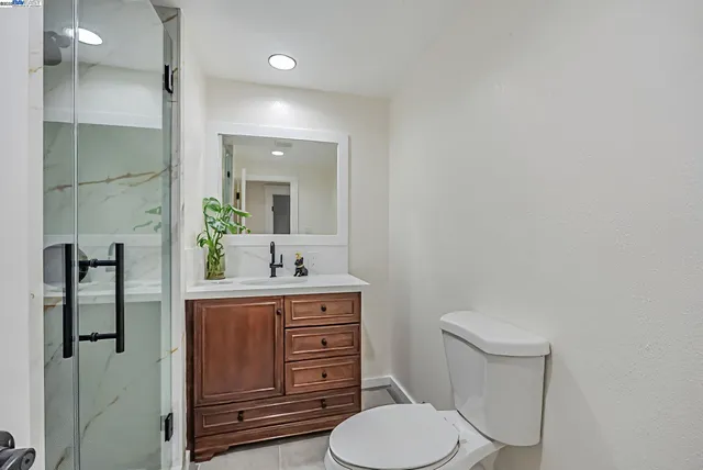 a bathroom with a toilet a sink and mirror