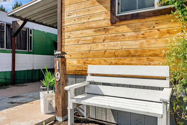 a view of a chairs and table in front of house