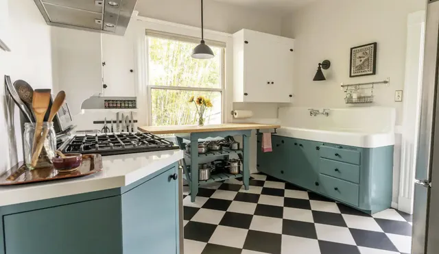 a kitchen with a sink a stove and a window