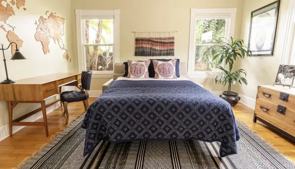 a bedroom with a bed and wooden floor