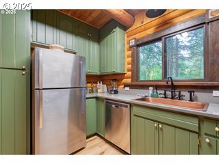 67930 East Stage Stop Road Welches, OR 97067 - Photo 15 of 43 a kitchen with a sink a refrigerator and a sink