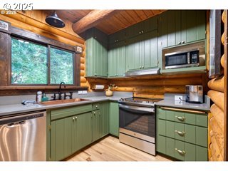 67930 East Stage Stop Road Welches, OR 97067 - Photo 16 of 43 a kitchen with a sink cabinets and window