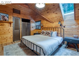 67930 East Stage Stop Road Welches, OR 97067 - Photo 17 of 43 a bedroom with a bed with wooden floor