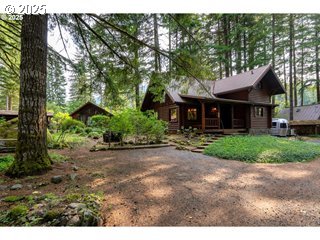67930 East Stage Stop Road Welches, OR 97067 - Photo 2 of 43 a front view of a house with a garden