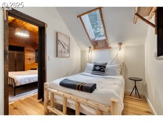 67930 East Stage Stop Road Welches, OR 97067 - Photo 21 of 43 a bedroom with a bed and a flat tv screen on dresser