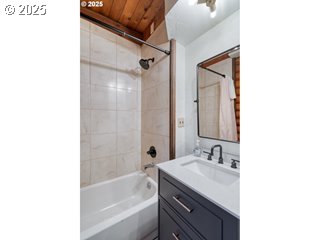 67930 East Stage Stop Road Welches, OR 97067 - Photo 40 of 43 a bathroom with a granite countertop sink a mirror a bathtub and shower