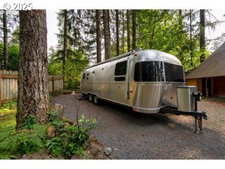 67930 East Stage Stop Road Welches, OR 97067 - Photo 41 of 43 a car parked in front of a house with a yard