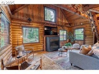 67930 East Stage Stop Road Welches, OR 97067 - Photo 6 of 43 a living room with furniture a fireplace and a flat screen tv