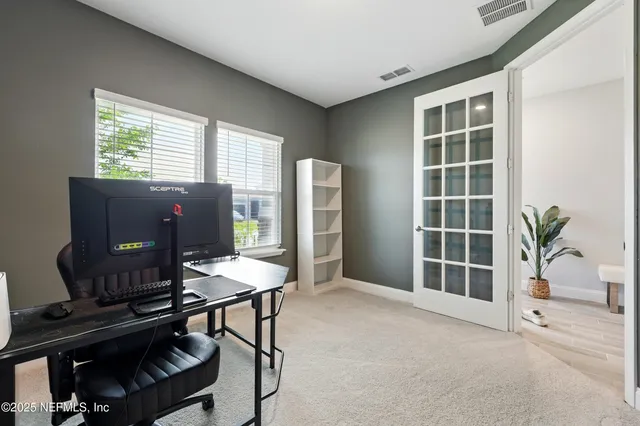 a view of a livingroom with furniture and a window