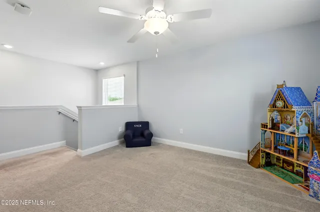 a view of an empty room with workspace and wooden floor