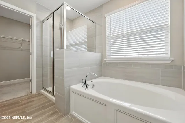 a white bath tub sitting next to a window