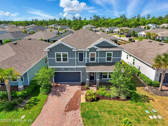 a aerial view of a house next to a yard