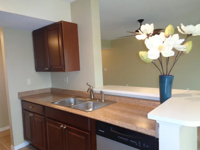 a view of a chairs and table in patio with a swimming pool