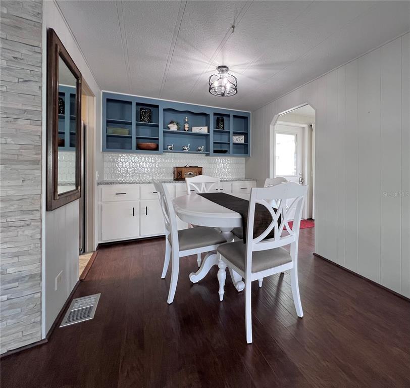 1100 South Belcher Road, Unit 772 Largo, FL 33771 - Photo 14 of 84 a view of a dining room with furniture and chandelier