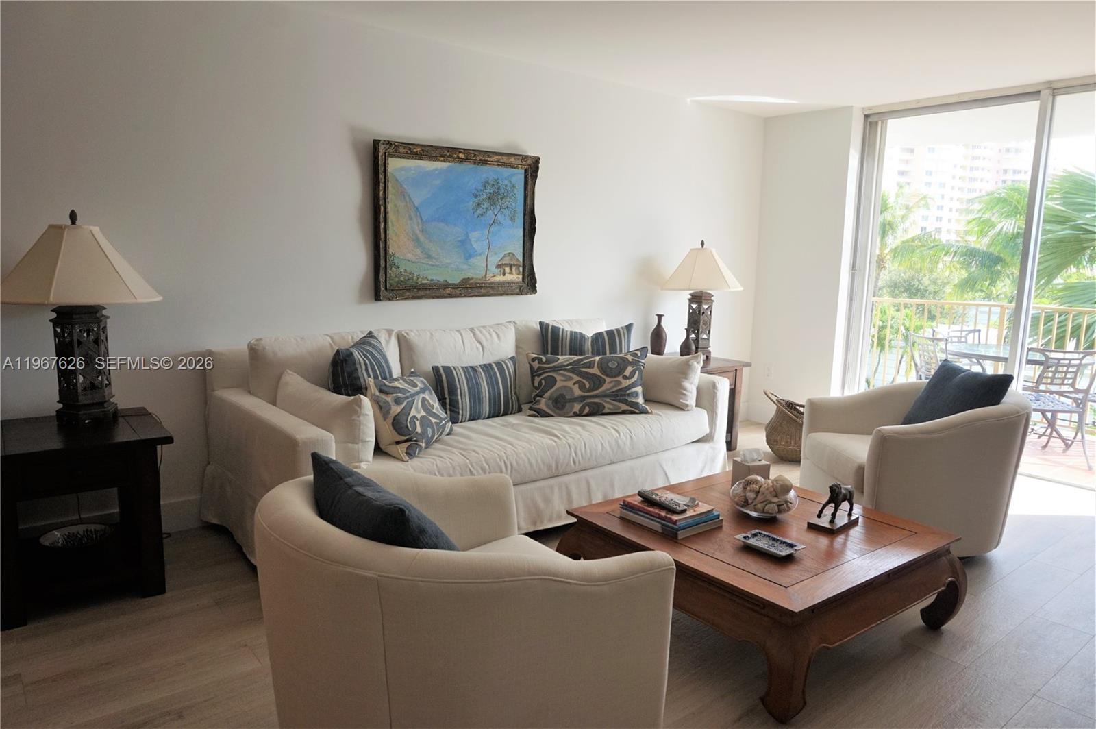 210 Seaview Drive, Unit 408 Key Biscayne, FL 33149 - Photo 1 of 34 a living room with furniture a rug and a large window