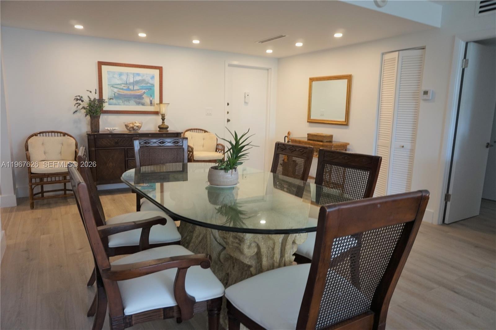 210 Seaview Drive, Unit 408 Key Biscayne, FL 33149 - Photo 12 of 34 a view of a dining room with furniture and wooden floor
