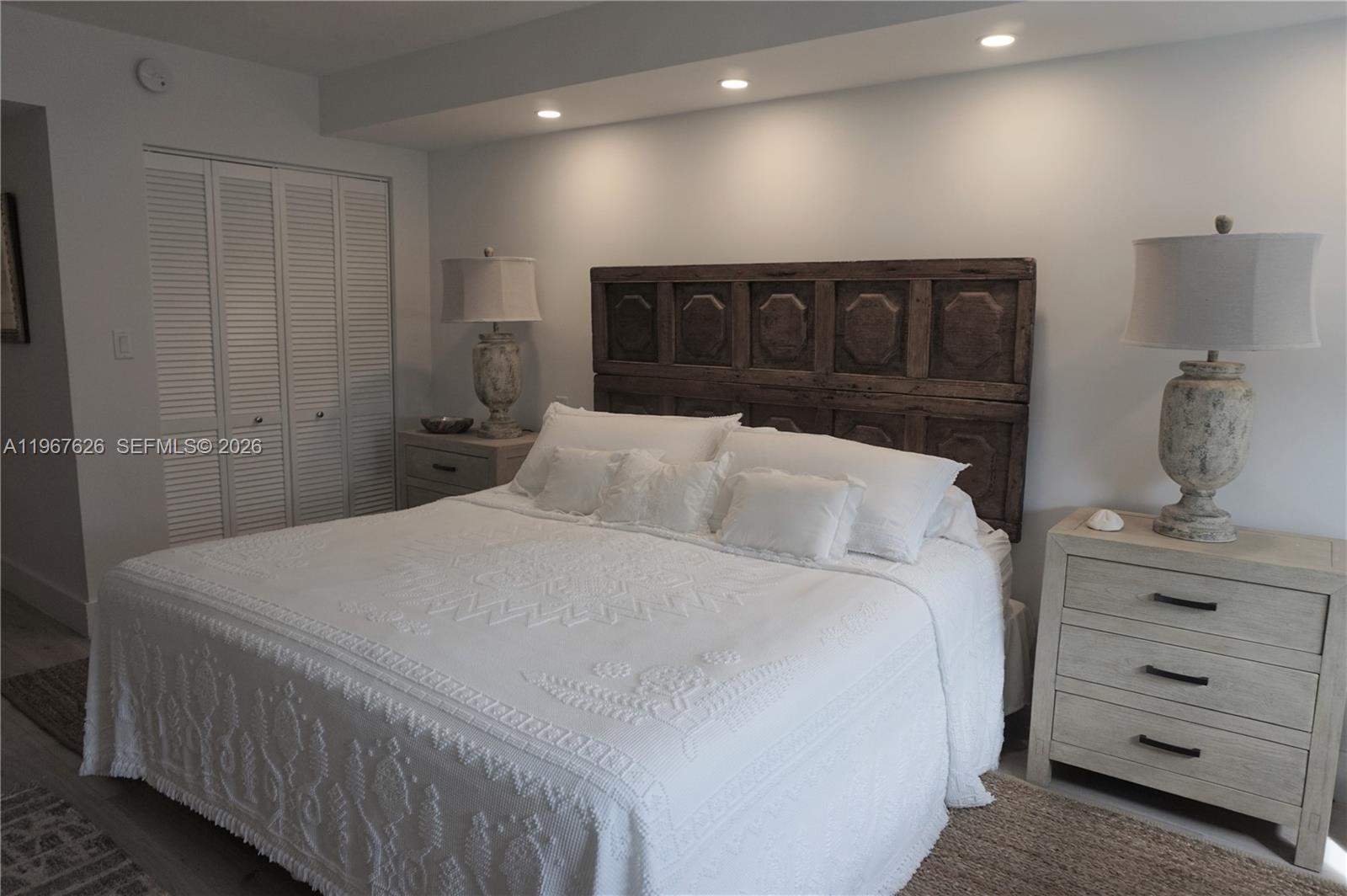 210 Seaview Drive, Unit 408 Key Biscayne, FL 33149 - Photo 14 of 34 a bedroom with a bed and cabinet