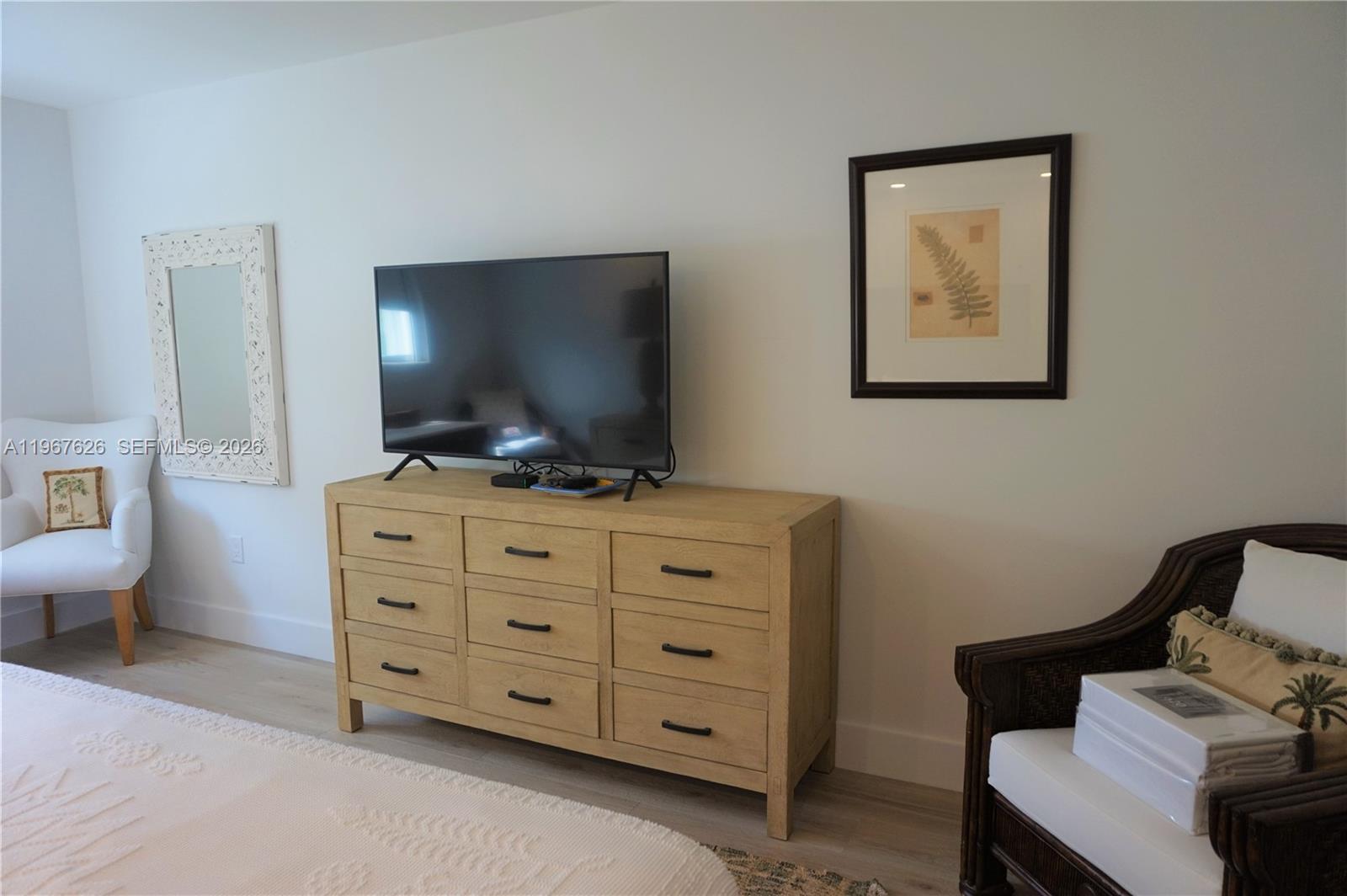 210 Seaview Drive, Unit 408 Key Biscayne, FL 33149 - Photo 16 of 34 a living room with furniture and a flat screen tv