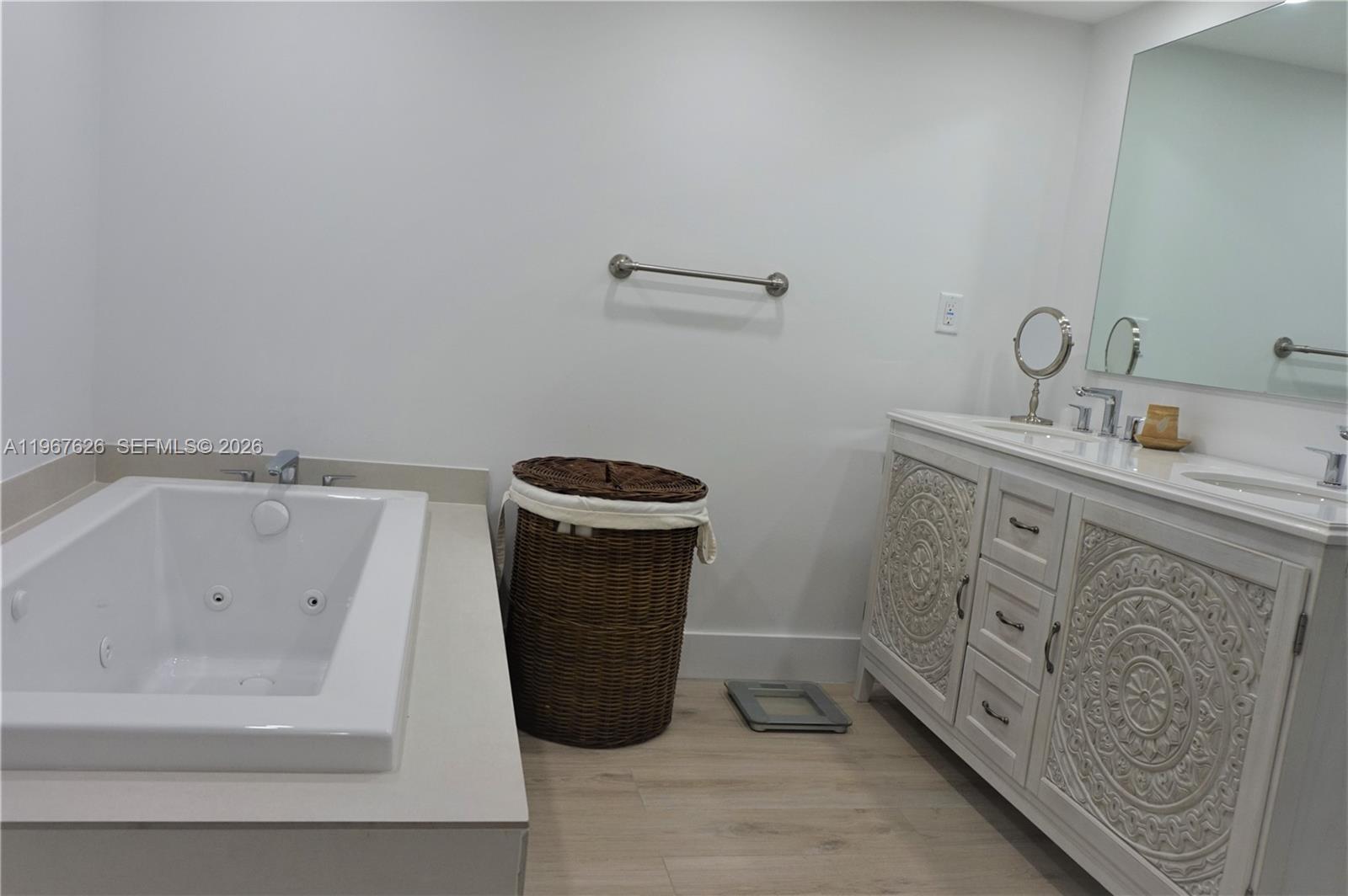 210 Seaview Drive, Unit 408 Key Biscayne, FL 33149 - Photo 19 of 34 a spacious bathroom with a granite countertop sink and a bathtub