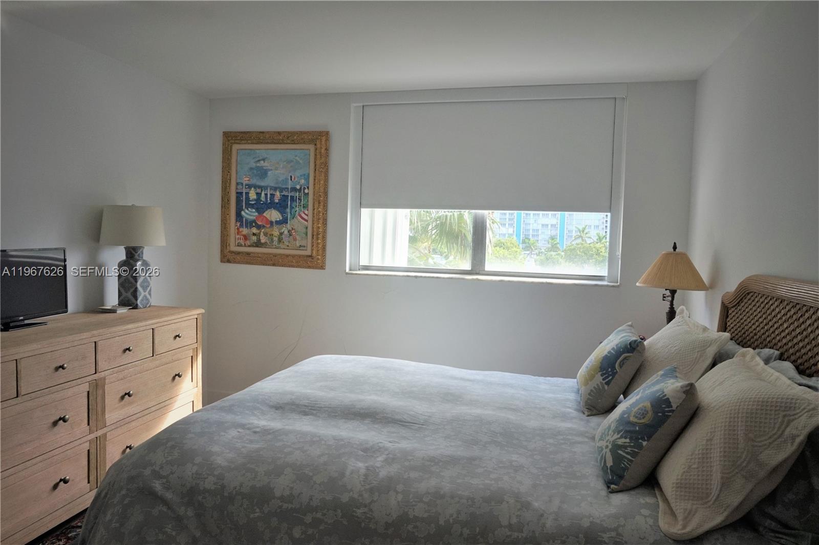 210 Seaview Drive, Unit 408 Key Biscayne, FL 33149 - Photo 20 of 34 a bedroom with a bed and a window