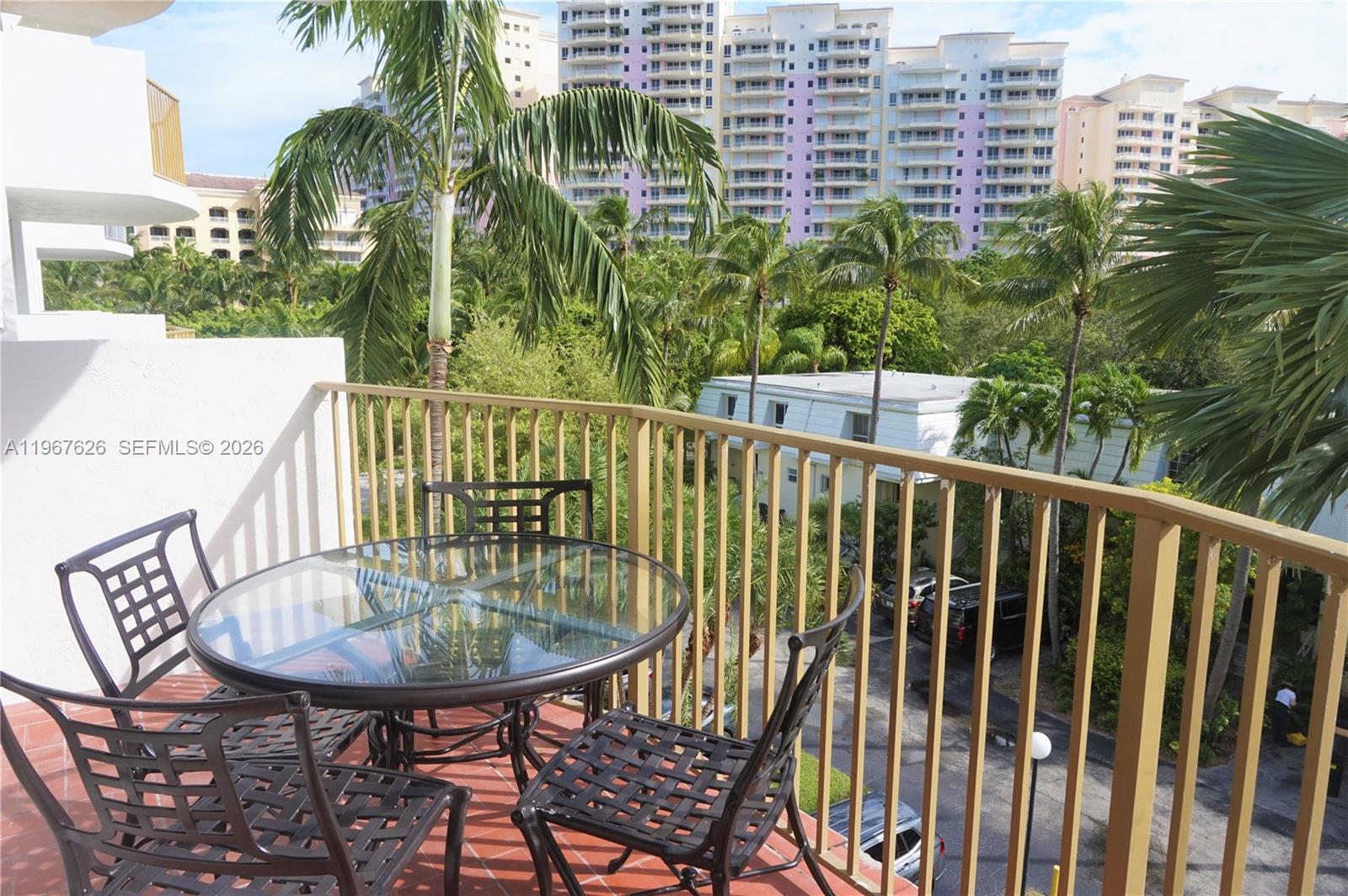 210 Seaview Drive, Unit 408 Key Biscayne, FL 33149 - Photo 2 of 34 a view of a balcony with a table and chairs
