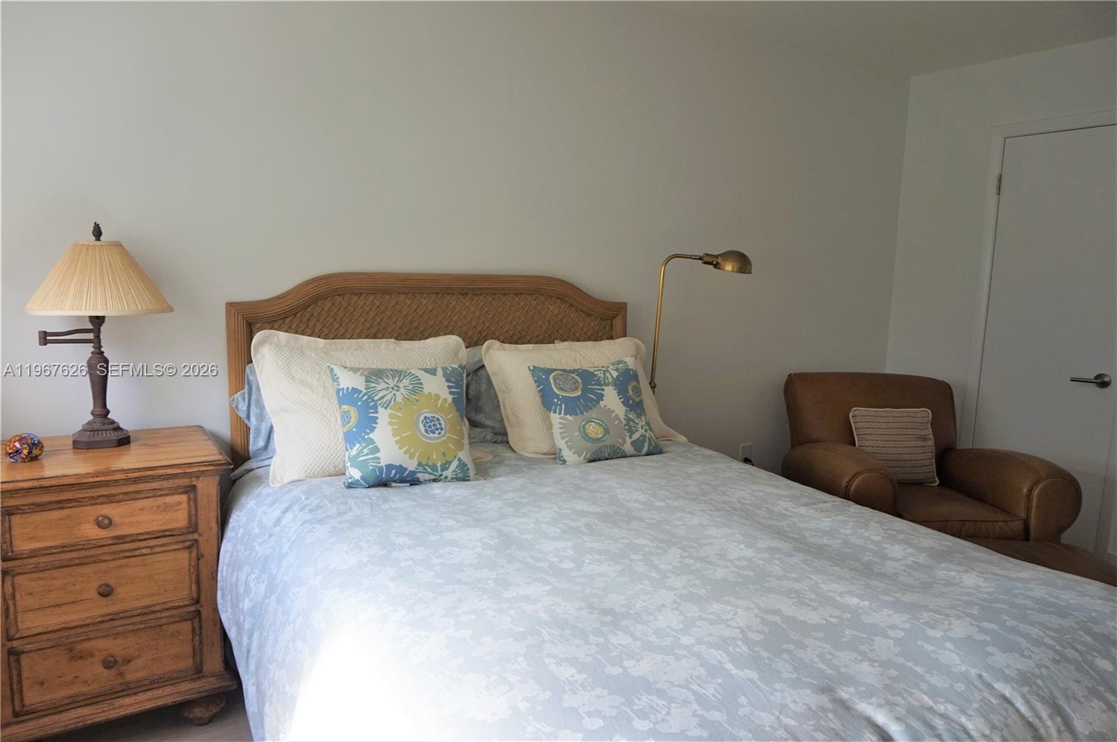 210 Seaview Drive, Unit 408 Key Biscayne, FL 33149 - Photo 21 of 34 a bedroom with a bed and lamp