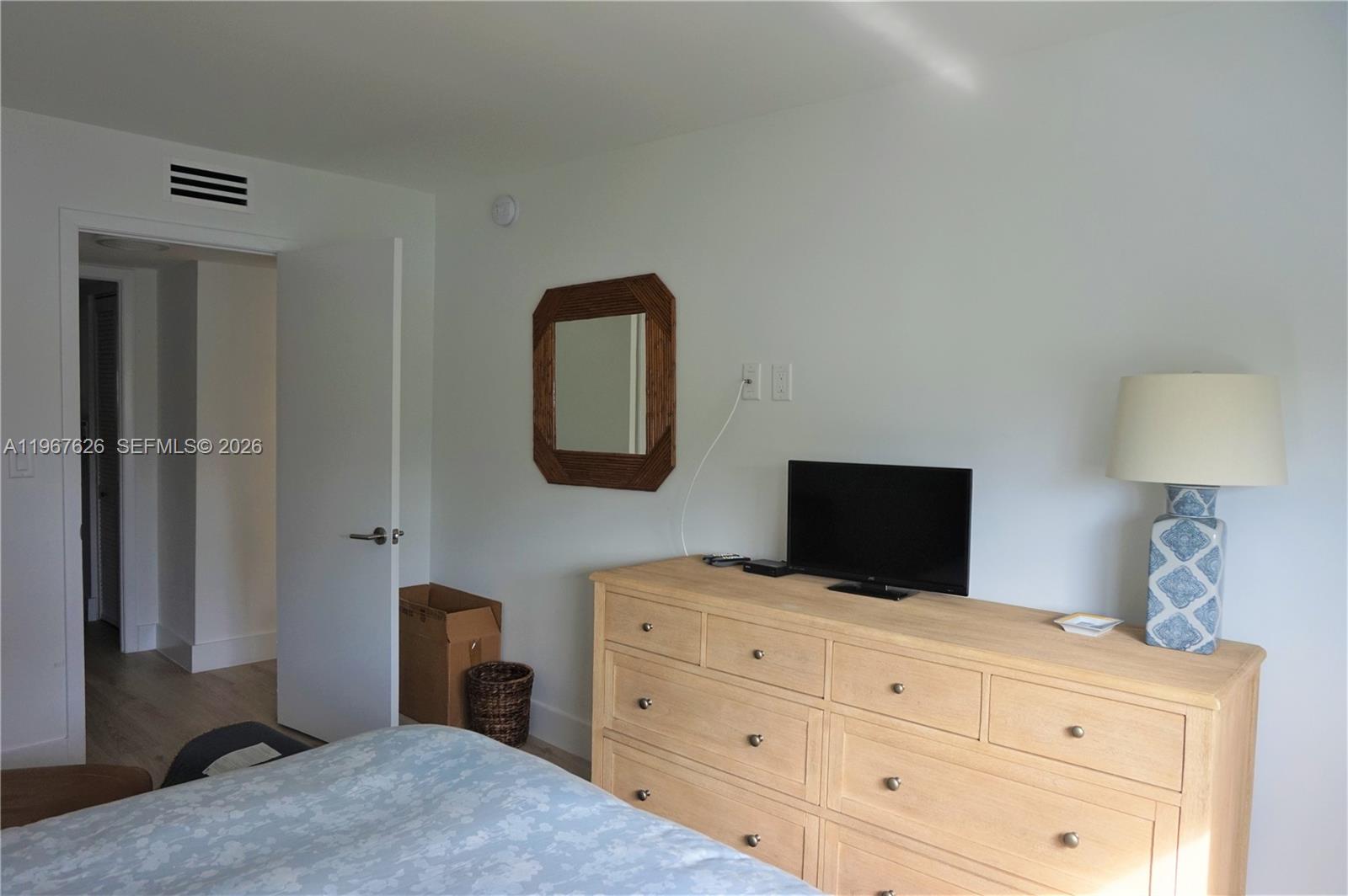 210 Seaview Drive, Unit 408 Key Biscayne, FL 33149 - Photo 22 of 34 a bedroom with a bed and a flat tv screen on dresser