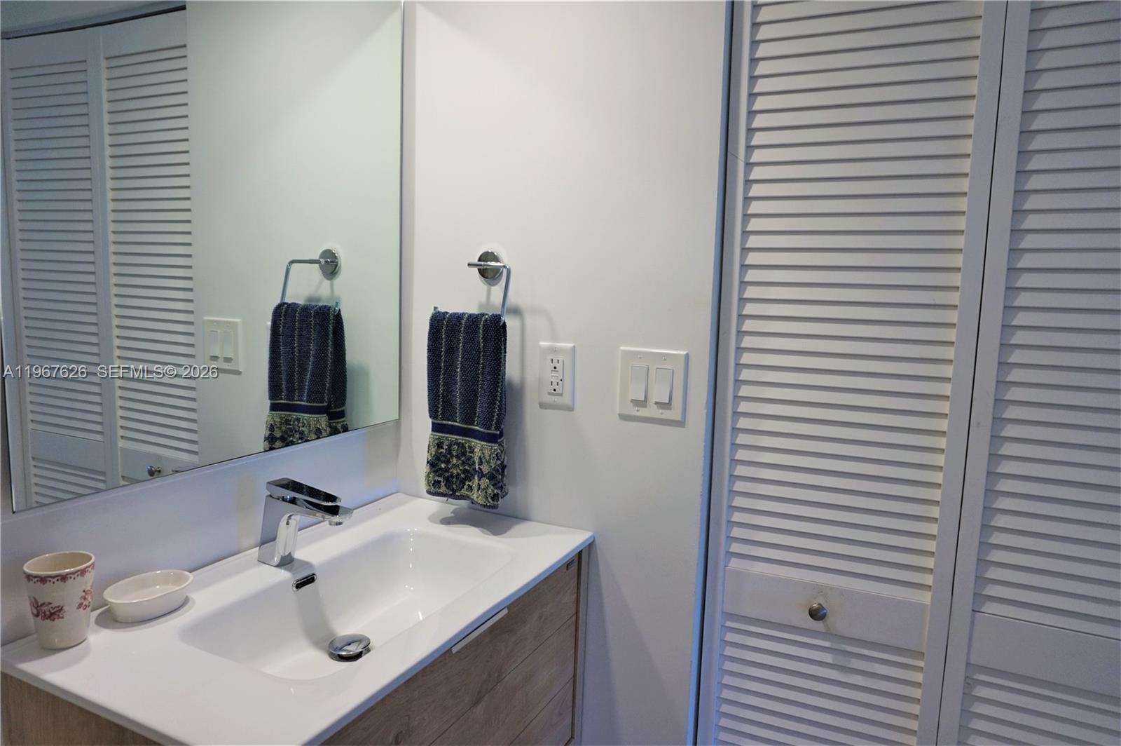 210 Seaview Drive, Unit 408 Key Biscayne, FL 33149 - Photo 23 of 34 a bathroom with a sink and a mirror