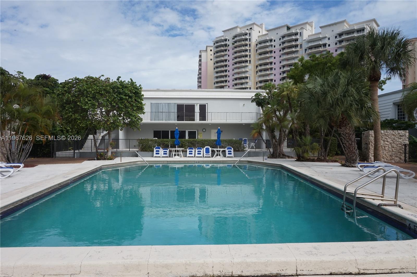 210 Seaview Drive, Unit 408 Key Biscayne, FL 33149 - Photo 29 of 34 a swimming pool with outdoor seating and yard