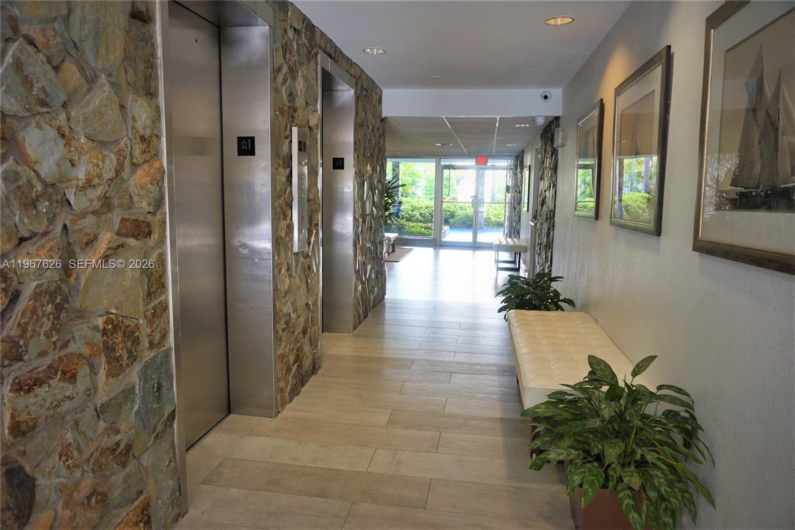 210 Seaview Drive, Unit 408 Key Biscayne, FL 33149 - Photo 31 of 34 a hallway with sliding door and wooden floor