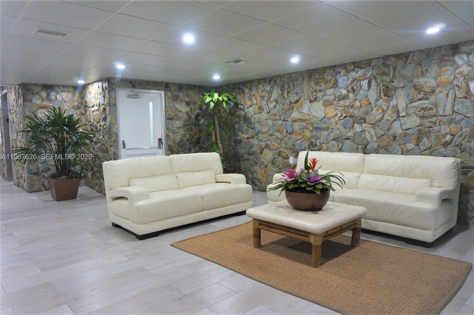 210 Seaview Drive, Unit 408 Key Biscayne, FL 33149 - Photo 32 of 34 a living room with furniture and a potted plant
