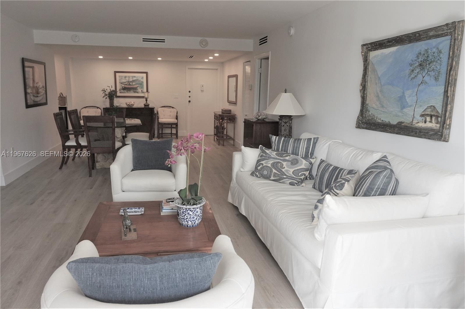 210 Seaview Drive, Unit 408 Key Biscayne, FL 33149 - Photo 5 of 34 a living room with furniture and a dining table