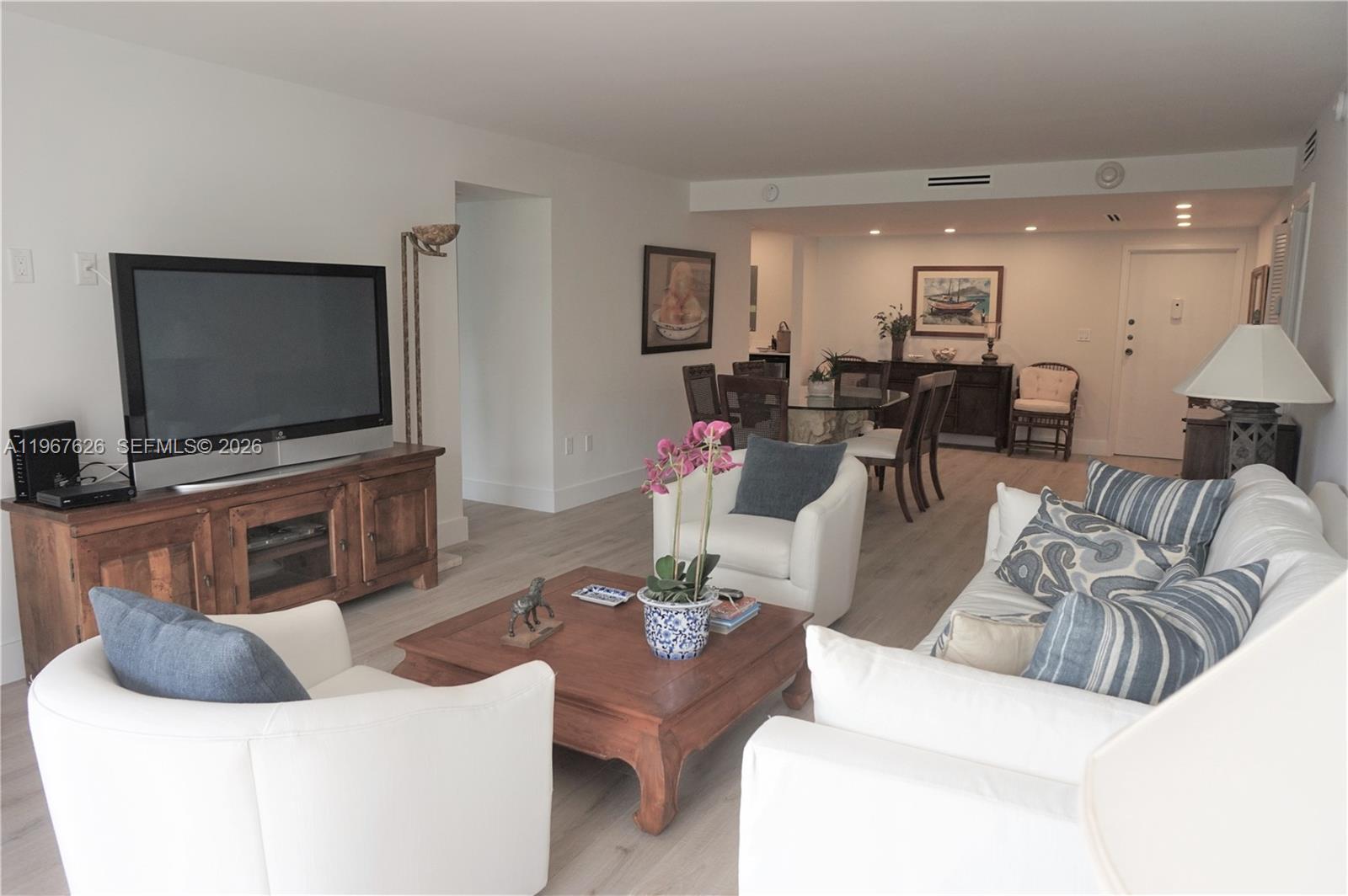 210 Seaview Drive, Unit 408 Key Biscayne, FL 33149 - Photo 6 of 34 a living room with furniture and a flat screen tv