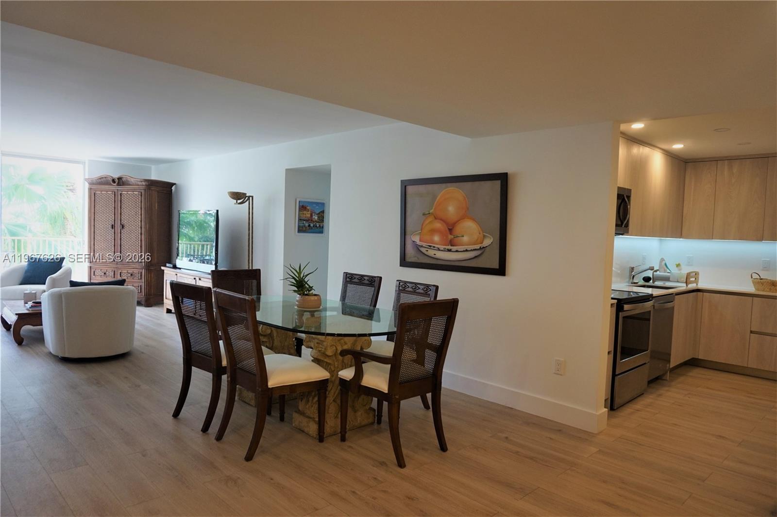 210 Seaview Drive, Unit 408 Key Biscayne, FL 33149 - Photo 8 of 34 a view of a dining room with furniture and wooden floor
