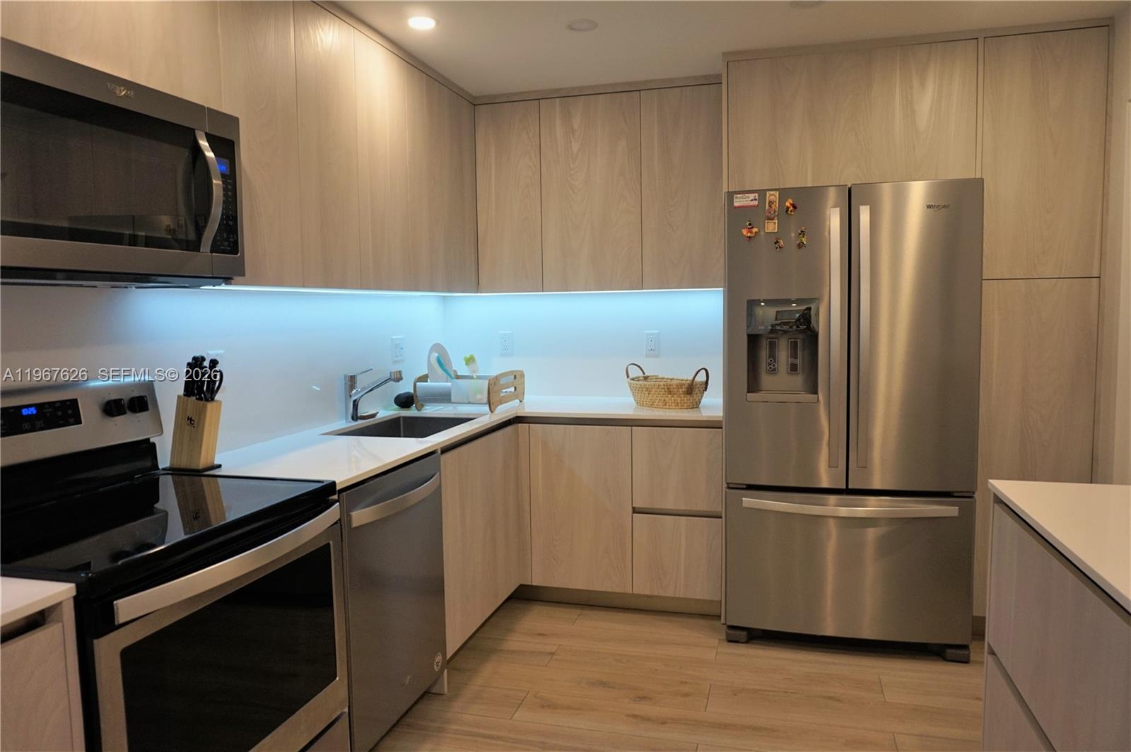 210 Seaview Drive, Unit 408 Key Biscayne, FL 33149 - Photo 9 of 34 a kitchen with a refrigerator and a sink